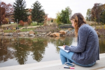 Physics and math double major Mary Aronne studying differential equations by the revamped pond.